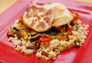 Pork Loins Served On Spicy Roasted Vegetables And Couscous